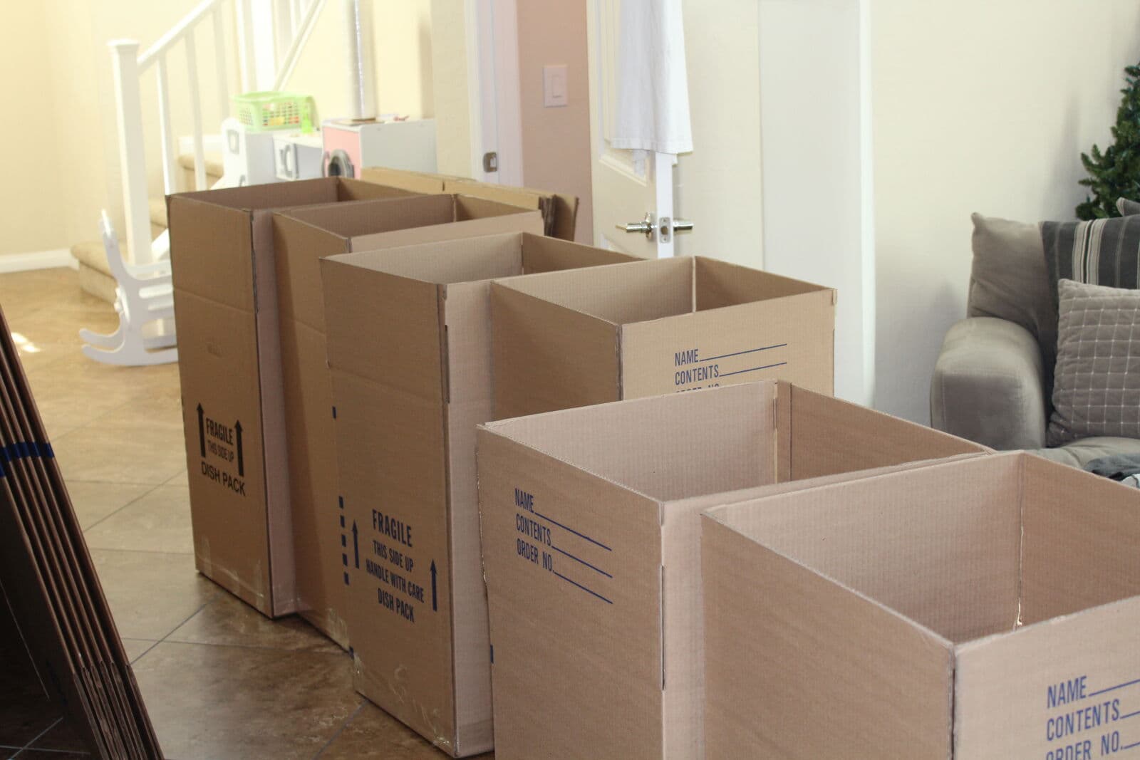 Packed cardboard moving boxes stacked in a home.